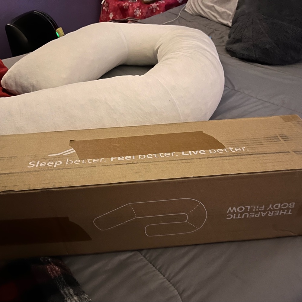 A 6 foot long soft body pillow all the white